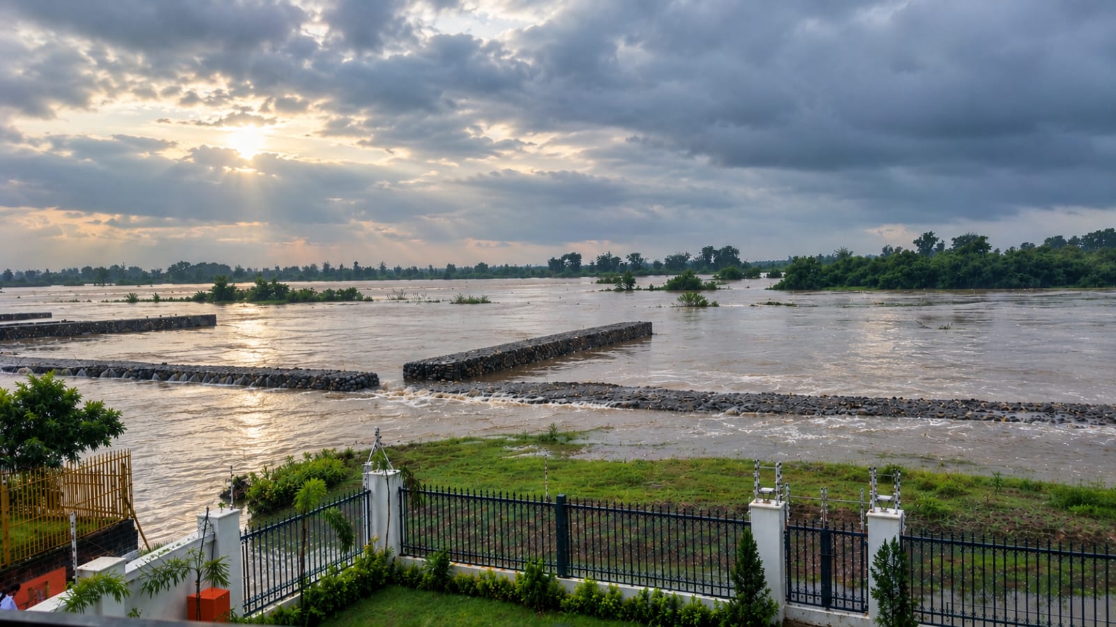 The Ganga in full monsoon flow, seen from the villa lawn on 25 September 2026